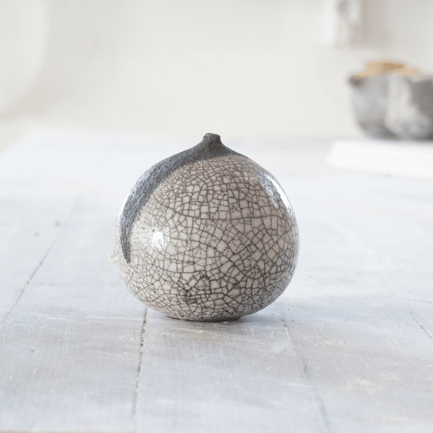 Raku-skulptur av Eva Paradis i grå och svart glasyr med krackeleringar och mjukt organisk form, handgjord på Öland.