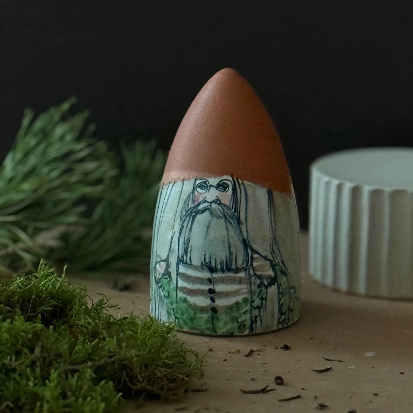 Tomte i keramik med brun luva och skägg